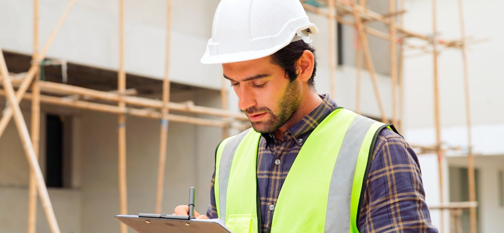 Construction worker looking at clipboard