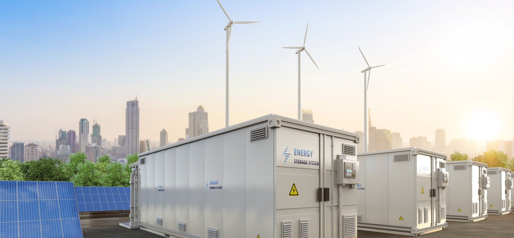 Electrical boxes and solar panels with a city skyline and wind turbines in background