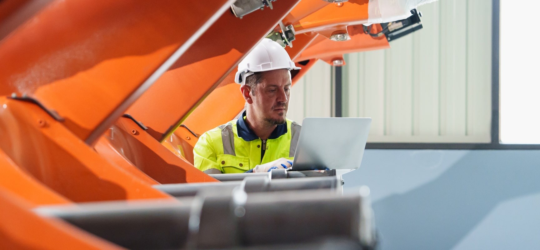 Construction engineer looking at laptop