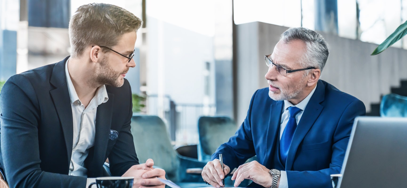 Two business professionals having a conversation over coffee