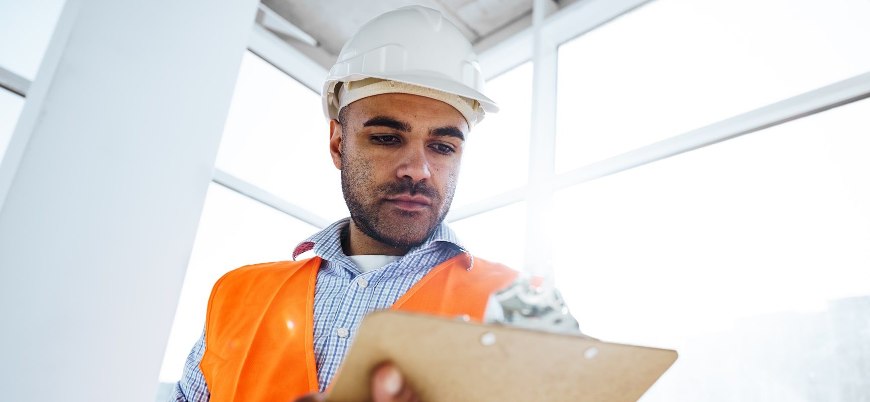 Construction worker looking at clipboard